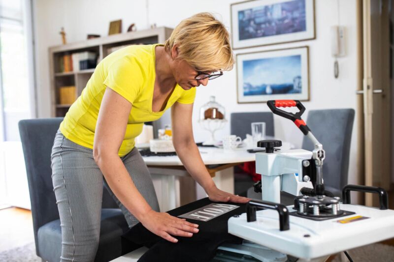 DTF transfer printing custom t-shirts at CustomTees for vibrant colors across many garment types and materials.